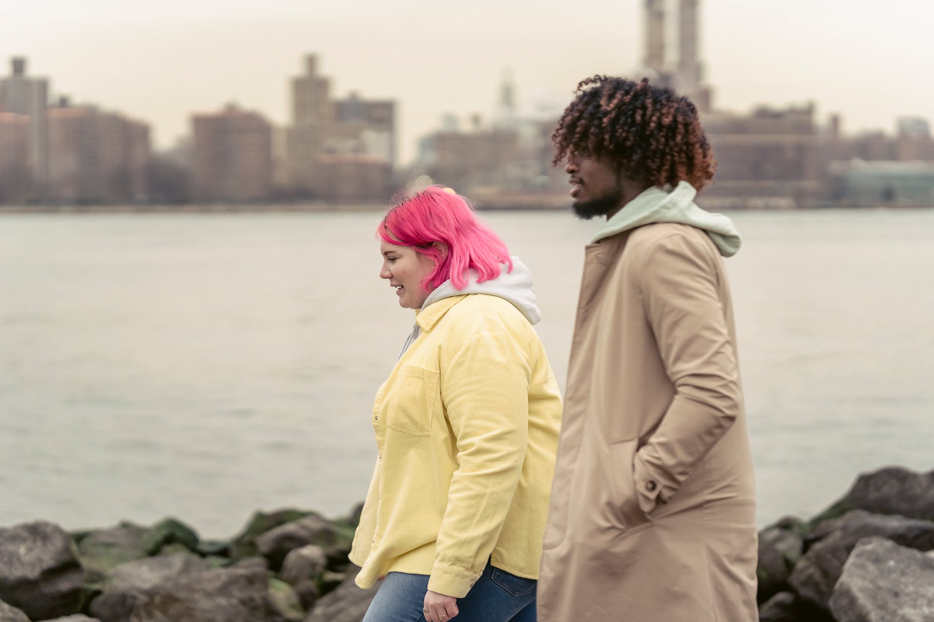 diverse friends walking along river bank