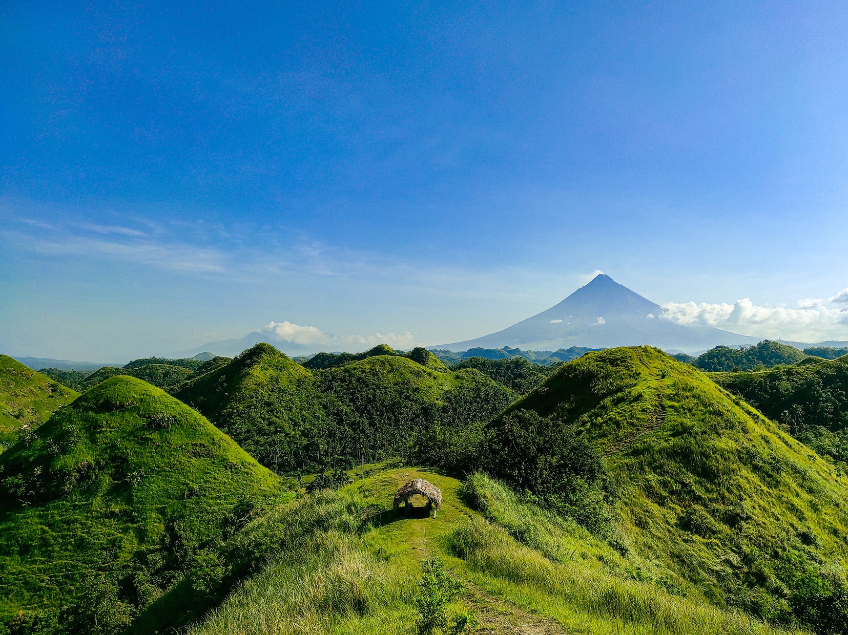 photo of hills under blue sky